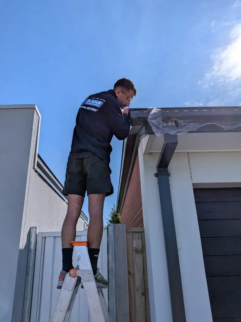 Roof plumber working on gutter in Elsternwick